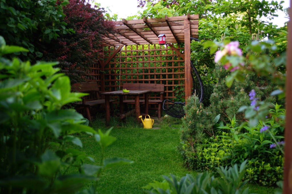 Garden gazebo with furniture, openwork walls and a roof